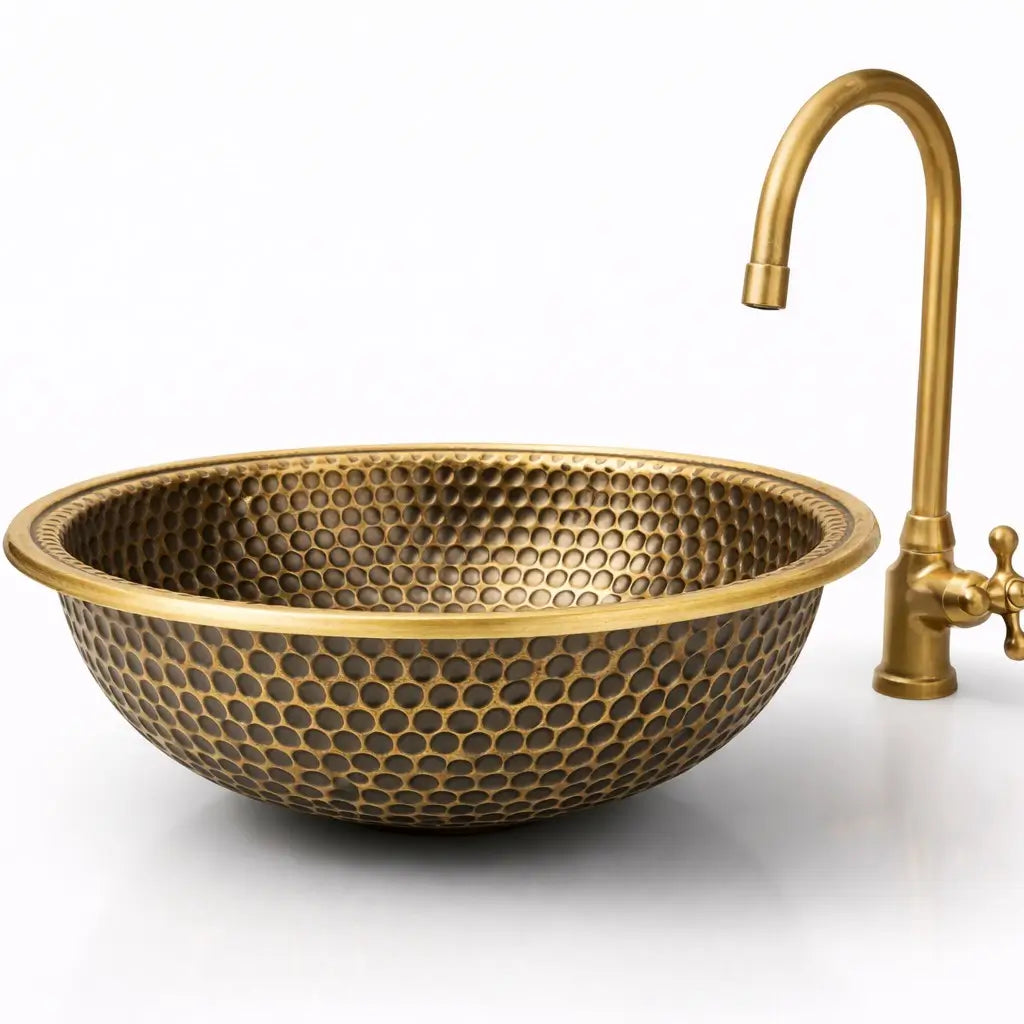 Close-up studio shot of a 16 gauge round vessel brass sink highlighting the dark honeycomb texture and golden rim.
