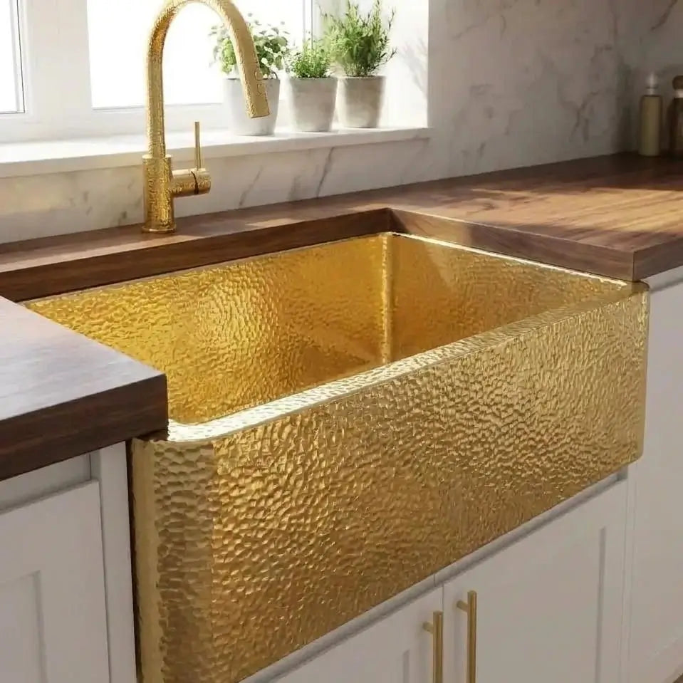 30-inch unlaquered brass apron front kitchen sink with a seamless undermount design installed in a dark wood countertop for easy clean-up