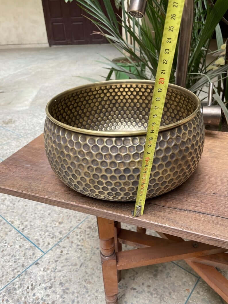 Hand hammered brass kitchen sink with honeycomb texture, showcasing Moroccan elegance for a unique kitchen design.