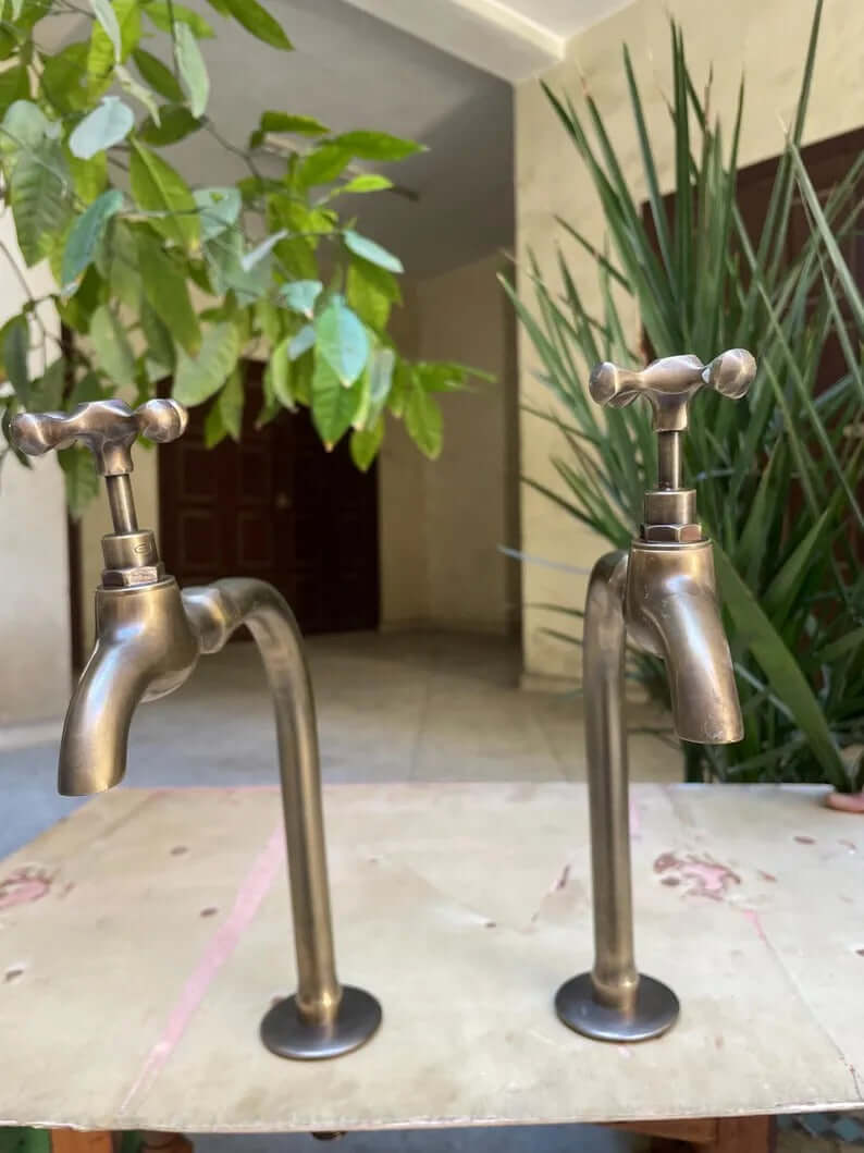 Premium handmade unlacquered brass dispensers featuring a vintage design with two handles and an elegant finish.