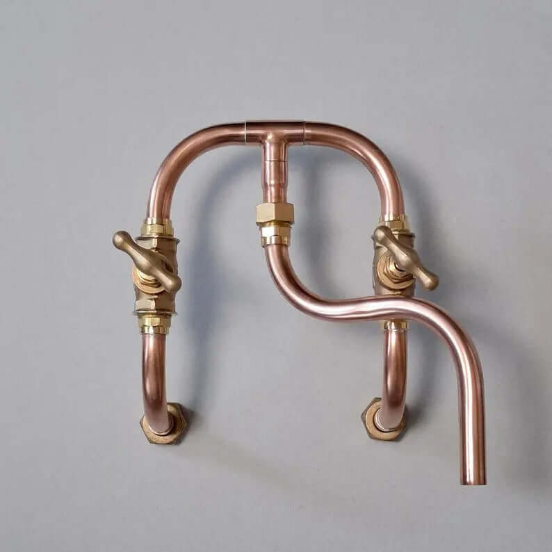 Handmade copper wall mount faucet with solid brass valves for kitchen or bathroom decor.