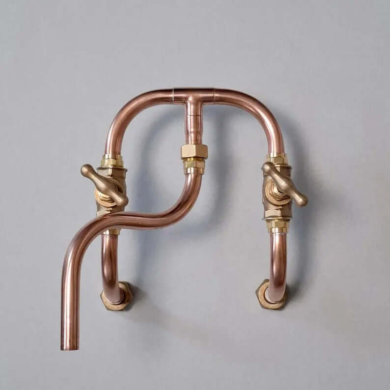 Handmade copper wall mount faucet with solid brass valves for kitchen and bathroom décor.