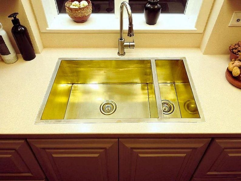 Handmade brass double square sink in a modern kitchen setting, showcasing polished surfaces and stylish design.