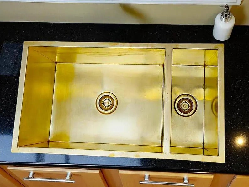Handmade brass double square sink on black countertop, showcasing classic Moroccan style and solid brass craftsmanship.