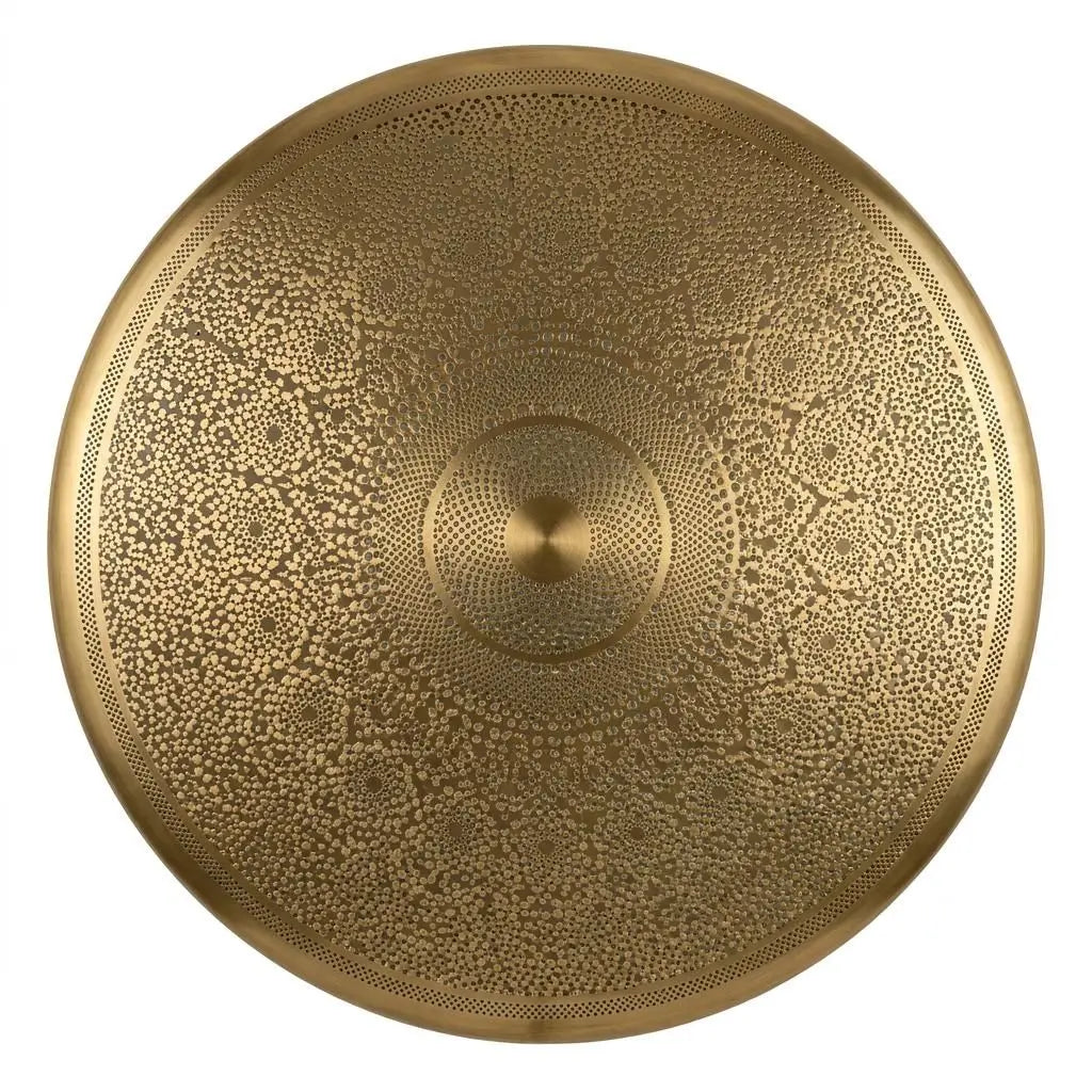 Close-up view of a circular hand-carved brass lamp shade displaying intricate geometric filigree patterns on a white background.