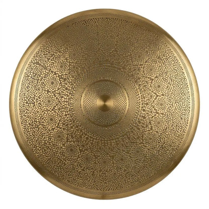 Close-up view of a circular hand-carved brass lamp shade displaying intricate geometric filigree patterns on a white background.