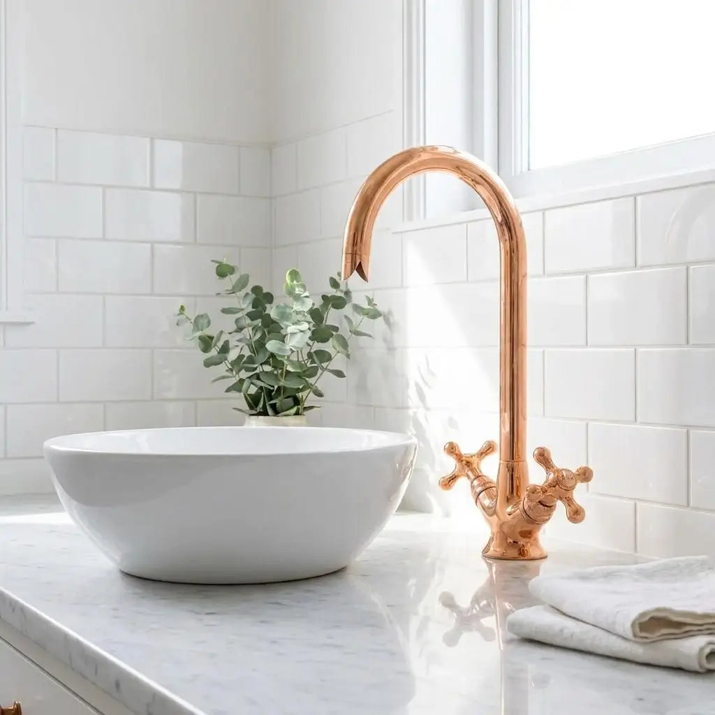 Polished copper gooseneck faucet paired with a white ceramic vessel sink against a white subway tile backsplash.