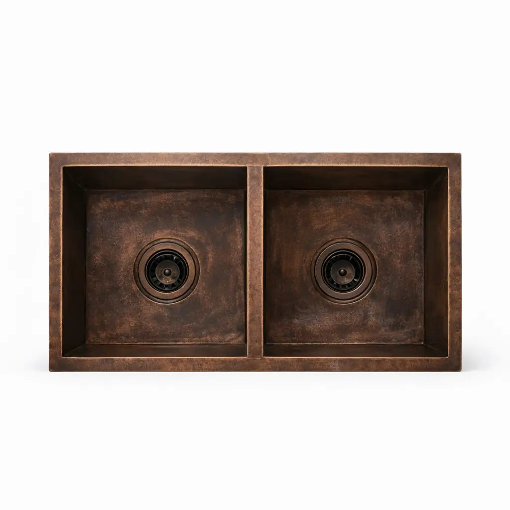 Front view of handmade dual bowl copper kitchen sink showing symmetrical basin design on a plain background