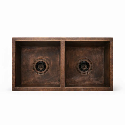 Front view of handmade dual bowl copper kitchen sink showing symmetrical basin design on a plain background