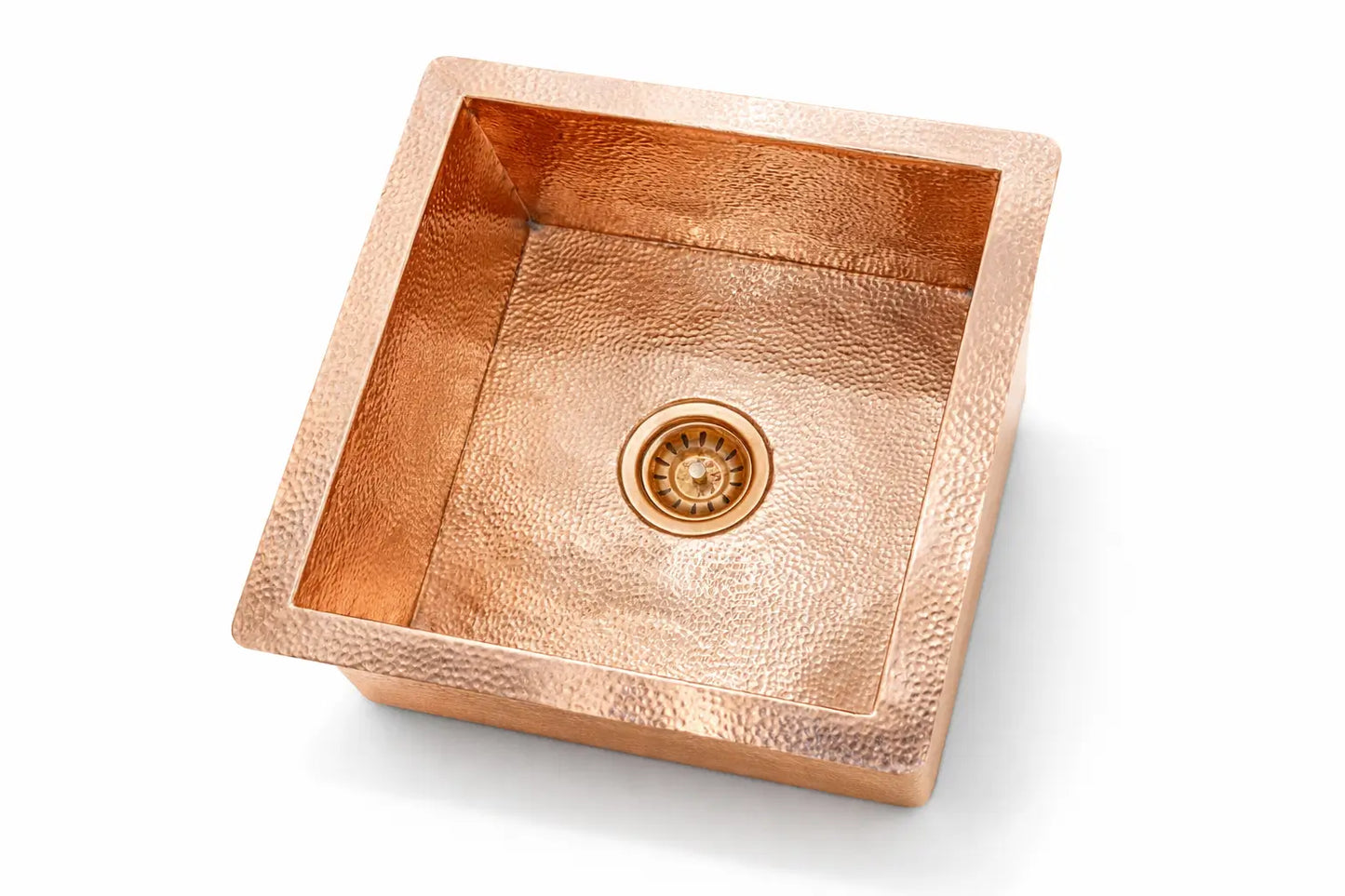 Handcrafted solid copper kitchen sink with a hand-hammered undermount design on a pure white background.