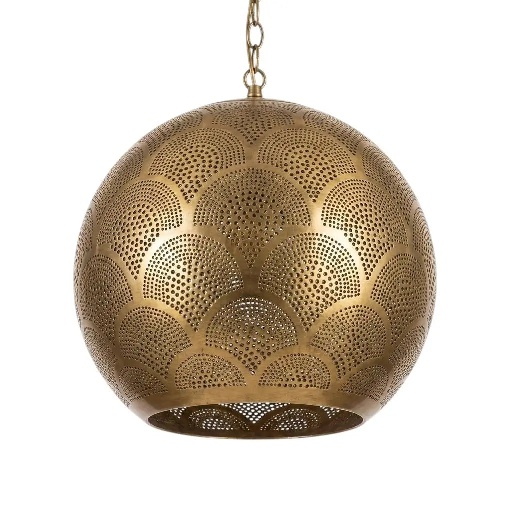 Spherical artisan handmade brass pendant light with detailed dot perforation isolated on a plain background