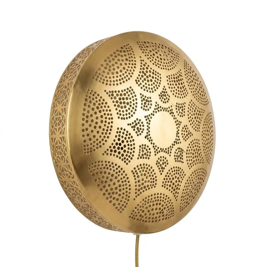 Close-up of a handmade minimalist brass wall sconce featuring intricate perforated geometric patterns and detailed craftsmanship for home lighting.