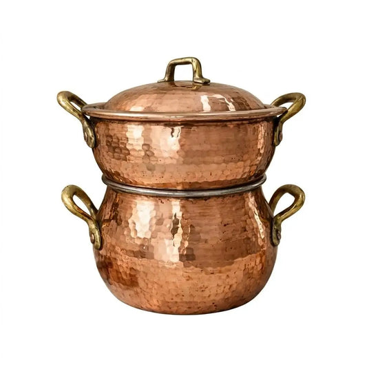 Handmade Moroccan copper couscoussier 2-tier steamer pot with lid isolated on a clean plain background.