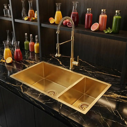 Luxury commercial juice bar design highlighting an undermount copper double basin sink with a commercial-style gold spring pull-down faucet on premium black marble.