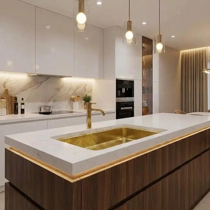 30 inch rectangular hammered copper kitchen sink set in a thick white quartz island countertop within a luxury modern open-concept apartment kitchen