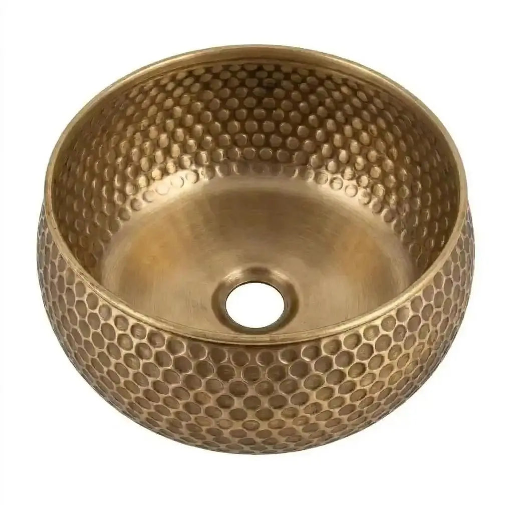 Mid-Century Modern Hammered Brushed Brass Sink with a honeycomb texture, luxury bathroom fixture isolated on a clean white background showing a top-angle view.