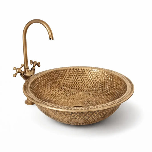 Modern custom made brushed brass bathroom sink with a round vessel design and high-arc antique brass faucet, isolated on a seamless white background for a clean e-commerce look.
