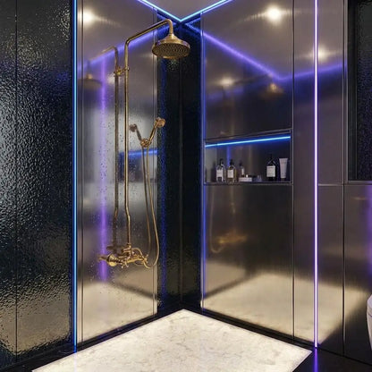 Unlacquered brass rain shower system with a Moroccan wall-mounted shower head and handheld unit, enclosed by a clear glass panel in a white marble bathroom.