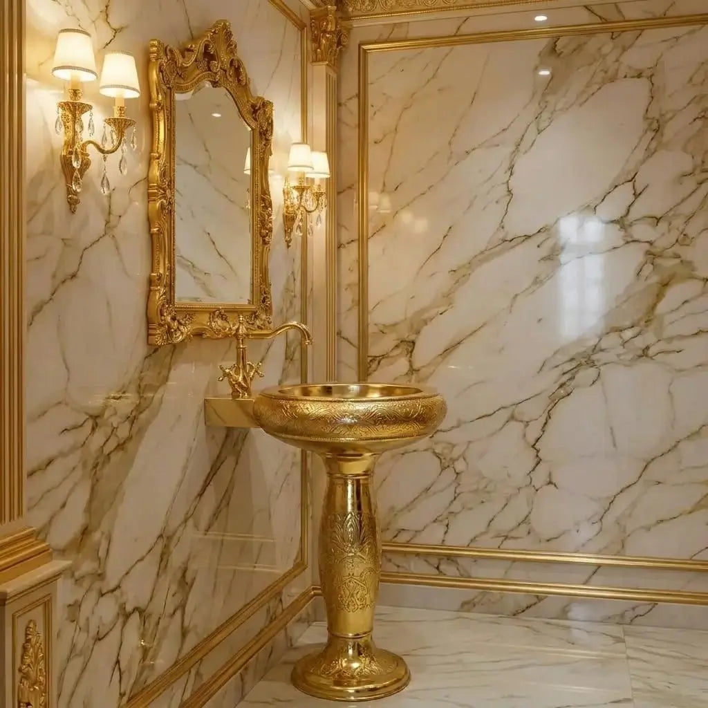 Moroccan engraved brass pedestal sink with a matching antique brass faucet, installed against a luxury white and gold veined marble wall background in a royal bathroom setting.