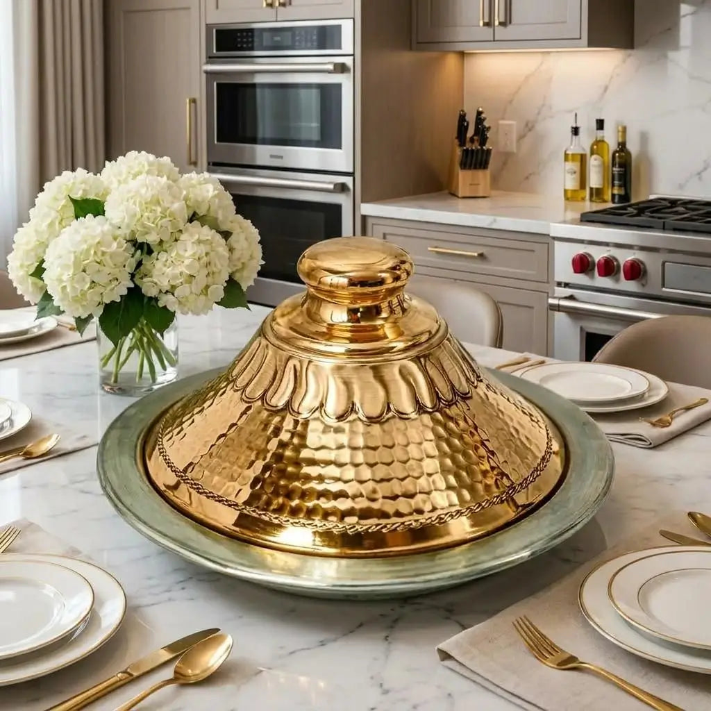 Handcrafted Moroccan copper tagine with a shiny hammered brass lid placed on a modern kitchen dining table setup