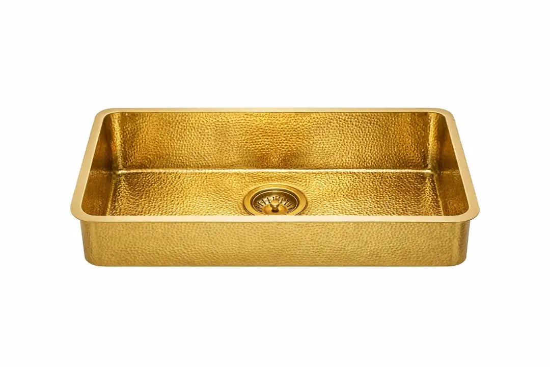 Front view of a rectangular golden brass bathroom sink with a detailed hammered pattern isolated on a white background