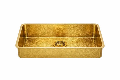 Front view of a rectangular golden brass bathroom sink with a detailed hammered pattern isolated on a white background
