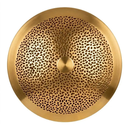 Close-up of a Moroccan wall light showing handmade artisan brass lighting with intricate perforated pattern and textured round metal design.