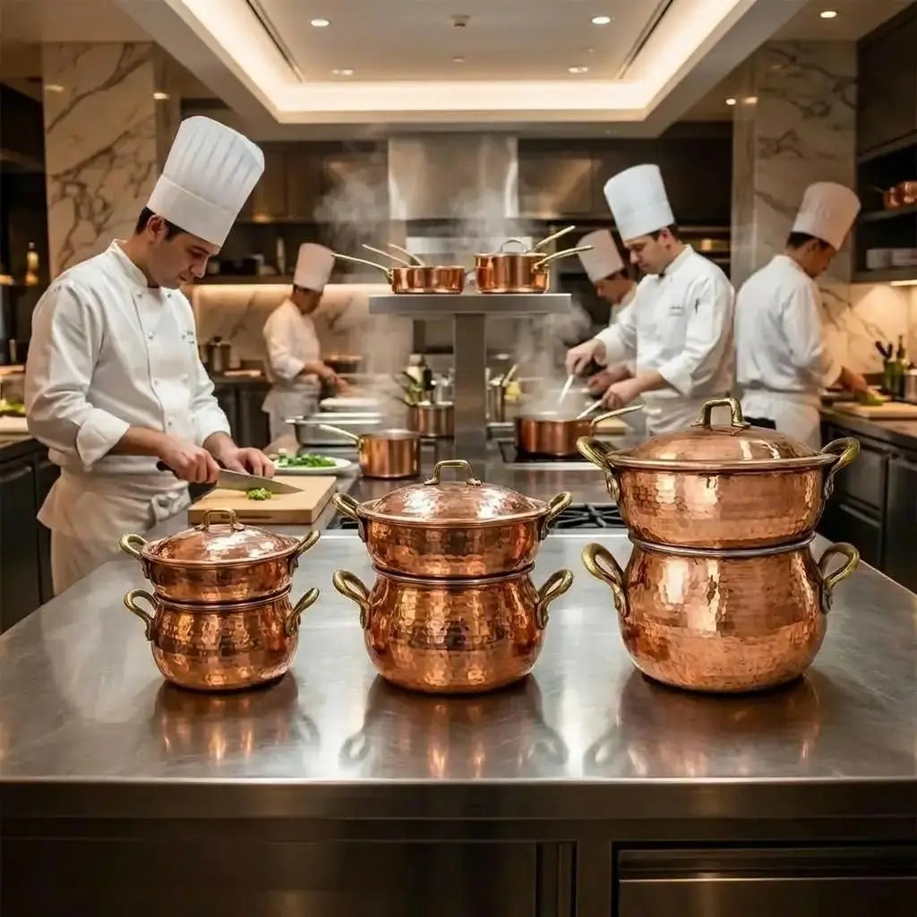Professional kitchen chefs preparing food with three distinct sizes of Moroccan copper couscoussier steamer pots.