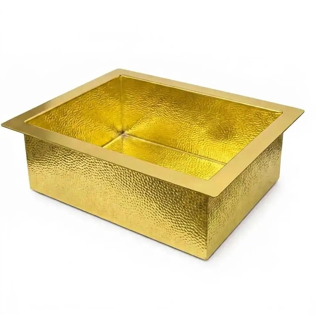 An angled view of a rectangular handcrafted brass Moroccan sink with a drop-in design and hammered texture, isolated on a clean white background.