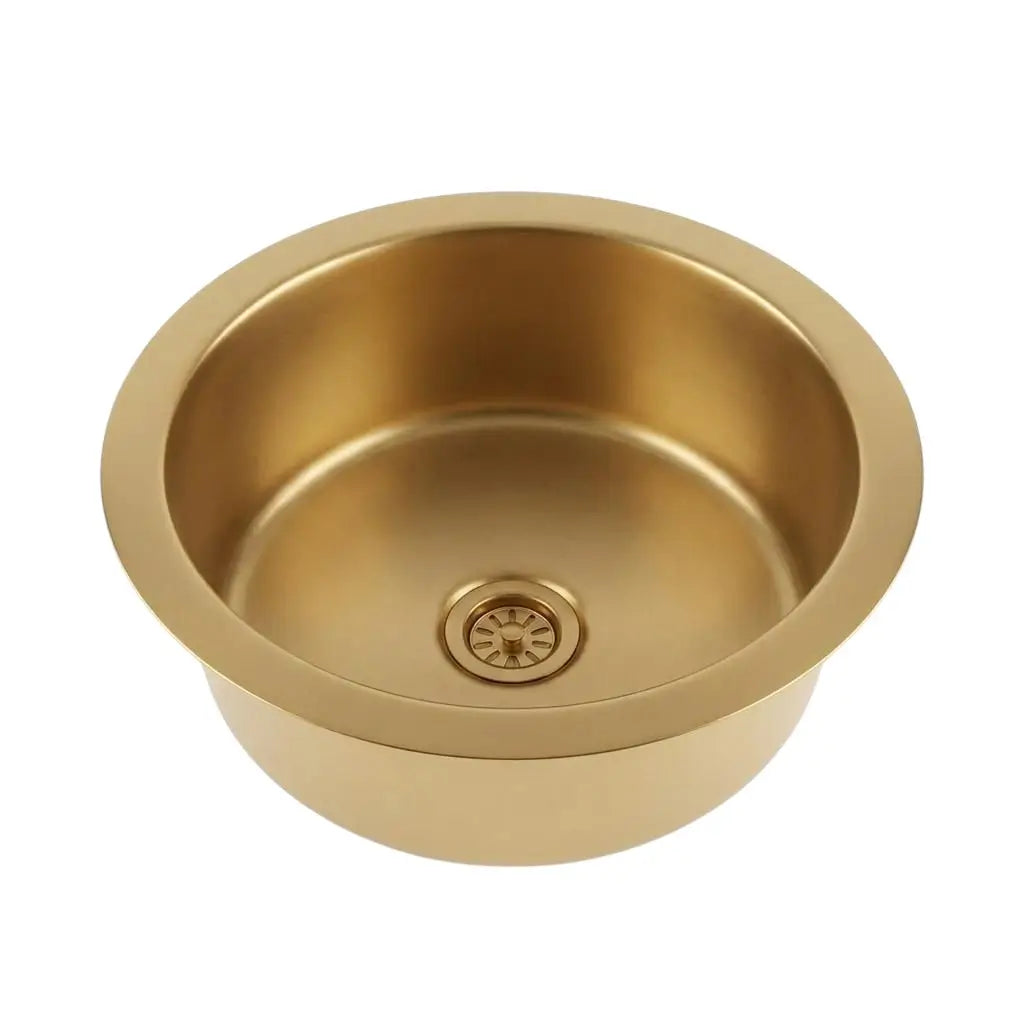 Top view of a round brushed brass drop-in sink with an integrated drain strainer isolated on a clean white background