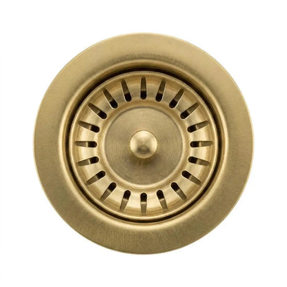 Close-up top view of a standard 3.5 inch solid brass kitchen sink waste disposal flange with a removable slotted strainer basket on a white background.