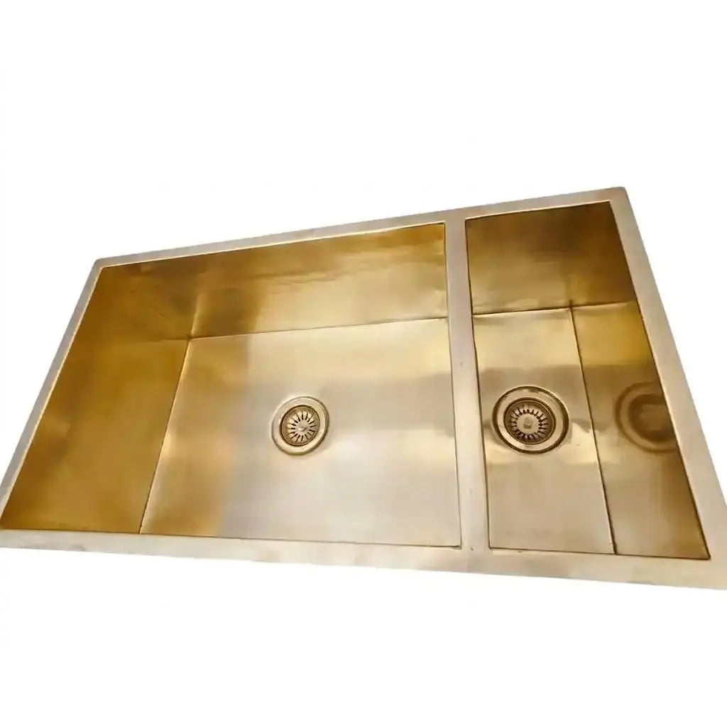 Top-down view of a modern handcrafted copper double basin kitchen sink with integrated drain strainers, showcasing a premium satin finish isolated on a white background.