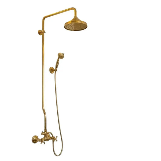 Unlacquered brass exposed pipe shower system featuring a large dome rainfall shower head, handheld sprayer, and cross handles isolated on a white background.