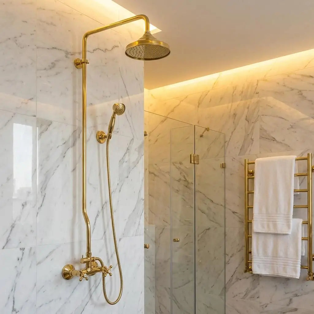 Unlacquered Brass Shower System with a Moroccan wall-mounted rain shower head and handheld sprayer installed in a modern marble bathroom.