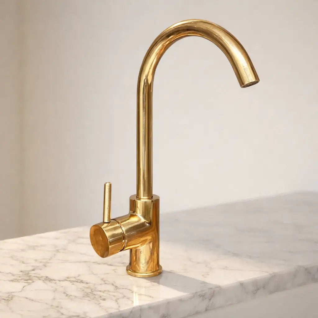 Unlacquered brass sink faucet with a modern curved design and a single handle.