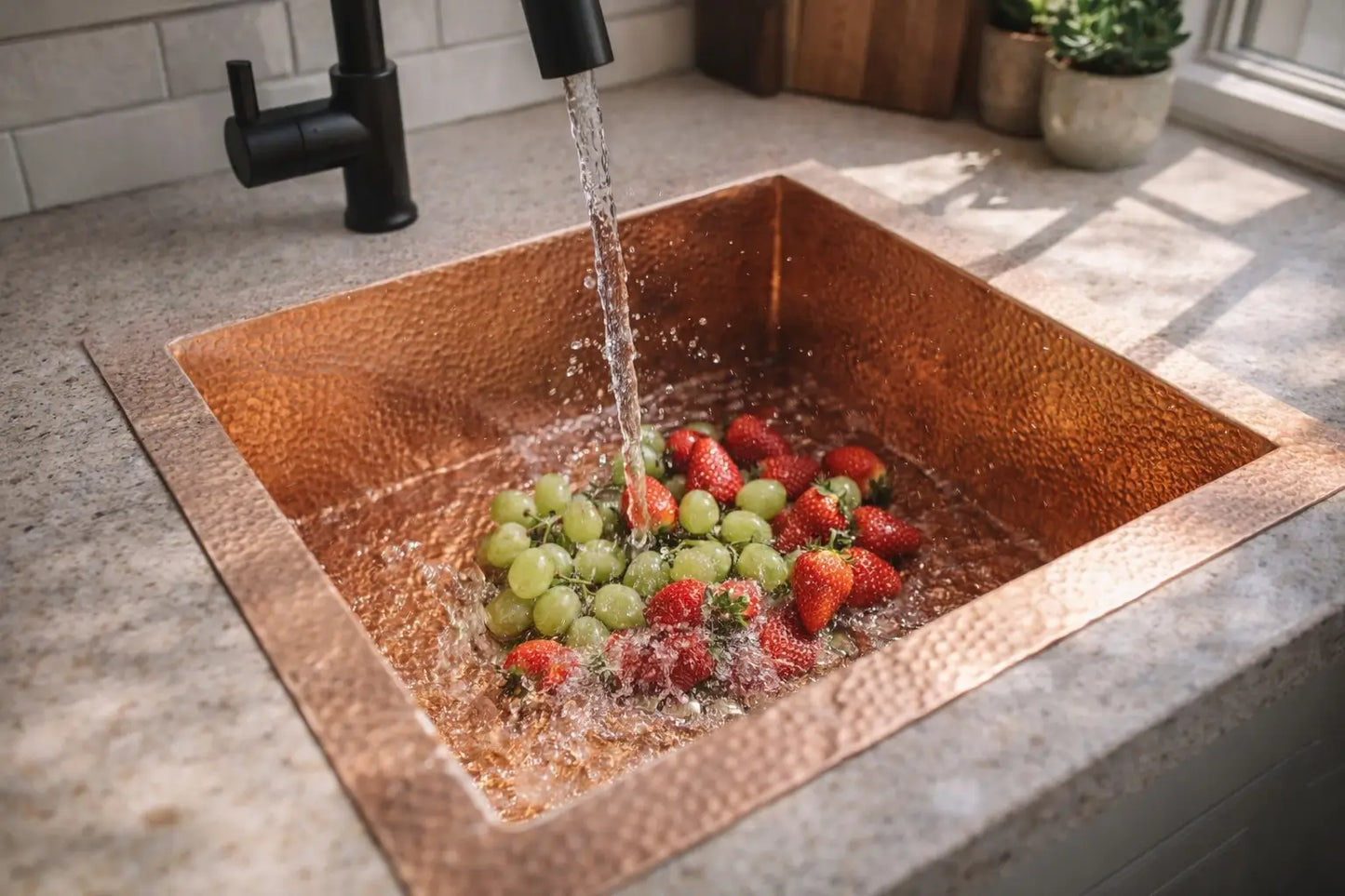 Water flowing over fruits inside an unlacquered copper sink highlighting its beautiful patina.