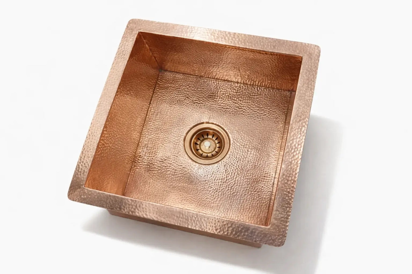 Unlacquered solid copper kitchen sink showing a customizable smooth finish from a top angle.