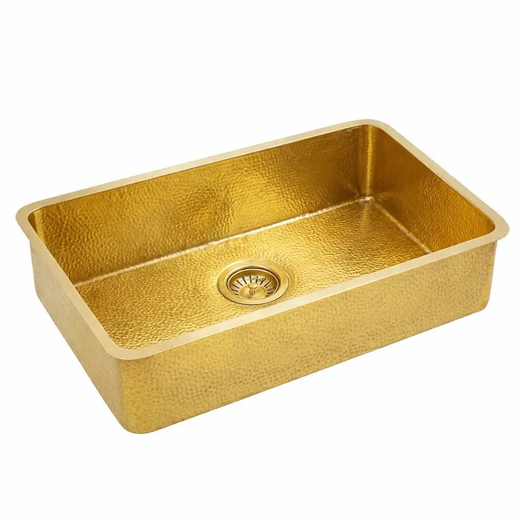 Rectangular golden brass bathroom sink with hammered texture isolated on a solid white background