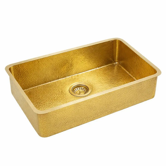 Rectangular golden brass bathroom sink with hammered texture isolated on a solid white background