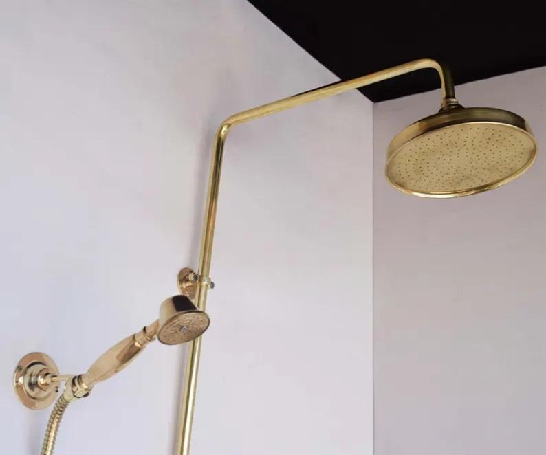 Unlacquered brass shower system featuring a round rain shower head and handheld sprayer, perfect for vintage-inspired bathrooms.